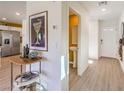 Bright foyer featuring wood-look floors, a stylish hall table, and a view of the half bath at 815 Calm Crystal Ct # Lot 146, North Las Vegas, NV 89081