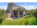 Inviting backyard featuring a covered patio and lush artificial grass, perfect for relaxing and entertaining at 831 E Galingale Ct, Henderson, NV 89015