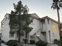 Exterior view of the condominium building with mature trees at 855 N Stephanie St # 2311, Henderson, NV 89014