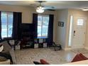 Cozy living room featuring tile floors, a ceiling fan, and lots of natural light at 903 Billings St, Henderson, NV 89002