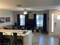 Bright living room with lots of natural light, a ceiling fan, and an open floorplan at 903 Billings St, Henderson, NV 89002