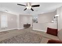 Spacious living room offering tile floors, neutral paint, and a modern ceiling fan at 903 Billings St, Henderson, NV 89002