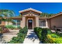 Inviting front entrance with lush landscaping and decorative stonework leading to a traditional front door at 906 Sitting Bull Dr, Henderson, NV 89014