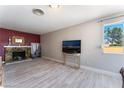 Open living room with stone fireplace and view of the backyard at 908 N 24Th St, Las Vegas, NV 89101