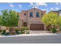 Charming two-story home with a well-maintained front yard, mature trees, and a two-car garage at 9643 Wildflower Vista Ave, Las Vegas, NV 89166