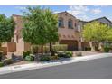Attractive two-story house featuring desert landscaping, a two-car garage, and a paver driveway at 9643 Wildflower Vista Ave, Las Vegas, NV 89166