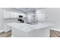 White kitchen showcasing stainless steel appliances, white cabinets and quartz countertops at 9766 Marcelline Ave, Las Vegas, NV 89148