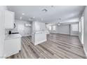 Expansive living area featuring modern flooring, a ceiling fan and a kitchen island at 9766 Marcelline Ave, Las Vegas, NV 89148