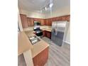 The kitchen features stainless steel appliances, wood cabinets, and ample counter space at 10455 Alpine Edge Ave, Las Vegas, NV 89129
