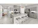Modern kitchen with stainless steel appliances, gray cabinets, and a spacious island with seating at 10951 Stone Crossing Ave, Las Vegas, NV 89166