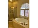 Bright bathroom featuring a soaking tub and glass-enclosed shower at 11625 Cabo Del Verde Ave, Las Vegas, NV 89138