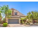 Inviting two-story home with lush landscaping, two-car garage, and quaint desert accents at 11625 Cabo Del Verde Ave, Las Vegas, NV 89138