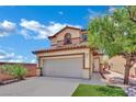 Charming two-story home with a tan exterior, tile roof, and an attached two-car garage at 11787 Fern Creek Ln, Las Vegas, NV 89183