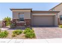 Beautiful exterior with stone accents, a two-car garage, and a well-maintained front yard at 12565 Huckleberry Oak Ave, Las Vegas, NV 89138
