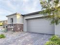 Spacious two-car garage with a modern gray door and stone accents on the exterior at 12565 Huckleberry Oak Ave, Las Vegas, NV 89138