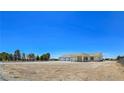 Expansive single-story home with a three-car garage on a large, mostly cleared lot at 1351 Huckleberry St, Pahrump, NV 89048