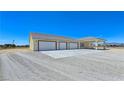 Attached three-car garage with white doors offers convenient parking and storage at 1351 Huckleberry St, Pahrump, NV 89048