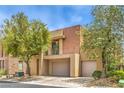 Contemporary two-story home featuring desert landscaping and a balcony at 1448 Canyon Ledge Ct, Las Vegas, NV 89117