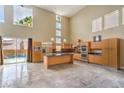 Spacious living room showcasing modern kitchen, high ceilings, and access to the pool at 1448 Canyon Ledge Ct, Las Vegas, NV 89117