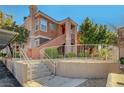 Inviting exterior of an apartment building featuring manicured landscaping and stair access to upper units at 1505 Blackcombe St # 202, Las Vegas, NV 89128