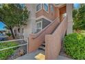 Exterior of an apartment building with well-maintained landscaping and a stairwell to the upper units at 1505 Blackcombe St # 202, Las Vegas, NV 89128