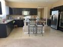 Spacious kitchen features dark cabinetry, stainless steel appliances, a center island, and lots of storage at 152 Lotus Vale Ave, Las Vegas, NV 89123