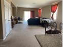 Open living room featuring carpet, sliding glass door, and neutral paint tones at 152 Lotus Vale Ave, Las Vegas, NV 89123