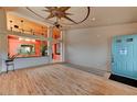 Spacious living area with wood floors, high ceilings, and a view of the entry with a blue front door at 1523 Silver Point Ave, Las Vegas, NV 89123