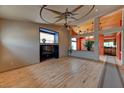 Open-concept living room with hardwood floors, custom ceiling fan, and unique architectural details at 1523 Silver Point Ave, Las Vegas, NV 89123