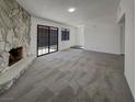 Spacious living room with neutral carpeting and a stone fireplace at 1832 Yellow Rose St, Las Vegas, NV 89108