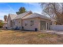 View of the house with a metal roof, stucco exterior, attached garage and spacious driveway at 1951 Jim Haworth Ct, Logandale, NV 89021