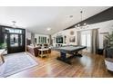 Spacious living area featuring a pool table, comfortable seating, and elegant lighting fixtures at 211 Kokopelli Ct, Henderson, NV 89074