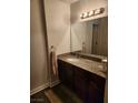 Simple bathroom featuring a vanity with granite countertop and a large mirror at 2606 S Durango Dr # 214, Las Vegas, NV 89117