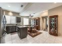 Open kitchen and dining area with stainless appliances, a center island, and a dining table at 310 Pissarro Pl, Henderson, NV 89074