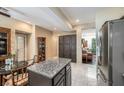 Bright, open kitchen with an island and lots of cabinet space, adjoined with a dining area at 310 Pissarro Pl, Henderson, NV 89074