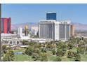 Golf course view, surrounded by lush trees, against the Las Vegas hotels and cityscape at 3111 Bel Air Dr # 22B, Las Vegas, NV 89109