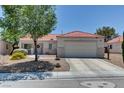 Charming single-story home with a well-manicured front yard and a two-car attached garage at 3823 Aspen Creek Ave, North Las Vegas, NV 89031