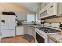 Well-lit kitchen featuring granite countertops, modern appliances, and ample cabinet space at 3823 Aspen Creek Ave, North Las Vegas, NV 89031
