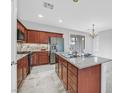 Modern kitchen with stainless steel appliances, granite counters, and a kitchen island at 4020 Recktenwall Ave, North Las Vegas, NV 89081