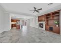 Open-concept living room featuring a fireplace, built-in shelves, and tile flooring at 4020 Recktenwall Ave, North Las Vegas, NV 89081