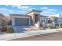 Attractive home featuring a paved driveway and walkway with low-maintenance landscaping, leading to a contemporary front entrance at 421 Point Sur Ave, Las Vegas, NV 89138