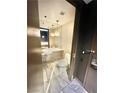 Modern bathroom featuring a vessel sink, marble floors, and stylish lighting at 4381 W Flamingo Rd # 2022, Las Vegas, NV 89103