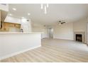Bright and airy living room featuring new floors, fireplace, open layout and a ceiling fan at 4810 Grey Wolf Ln # 104, Las Vegas, NV 89149