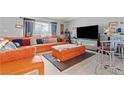 Comfortable living room boasts an orange sectional sofa and modern decor at 5004 Cannon Blvd, Las Vegas, NV 89108