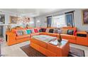 This well-lit living room features a stylish orange sectional sofa and decor at 5004 Cannon Blvd, Las Vegas, NV 89108