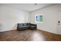 Cozy living room showcasing hardwood floors, a comfortable sofa, and lots of natural light at 532 Clearsable Ave, Henderson, NV 89044