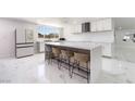 Open kitchen showcasing a large island with seating and stainless appliances at 5336 Regal Ave, Las Vegas, NV 89146