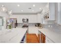 Well-lit kitchen featuring stainless steel appliances, wine rack, and island with seating at 5642 Breckenridge St, North Las Vegas, NV 89081