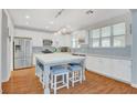 Bright kitchen with white cabinets, stainless appliances, and a large center island with seating at 5642 Breckenridge St, North Las Vegas, NV 89081