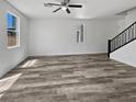 Bright living room with neutral walls, ceiling fan, and attractive wood-look floors at 5709 Jaysin Douglas St, North Las Vegas, NV 89031